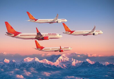 Four airplanes flying in formation over a mountain range.