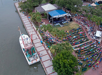 An aerial view of a boat and people on the water.