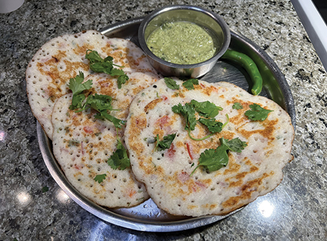 A plate of food with some green sauce on it