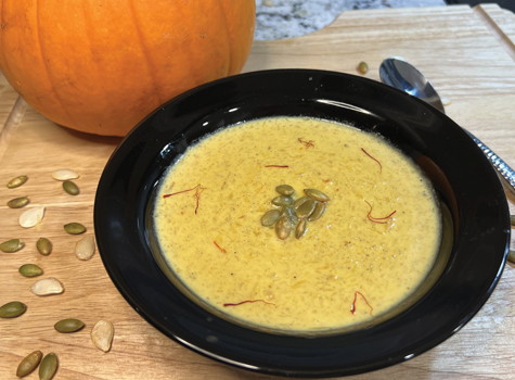 A bowl of soup on top of a table.