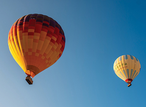 Two hot air balloons flying in the sky.